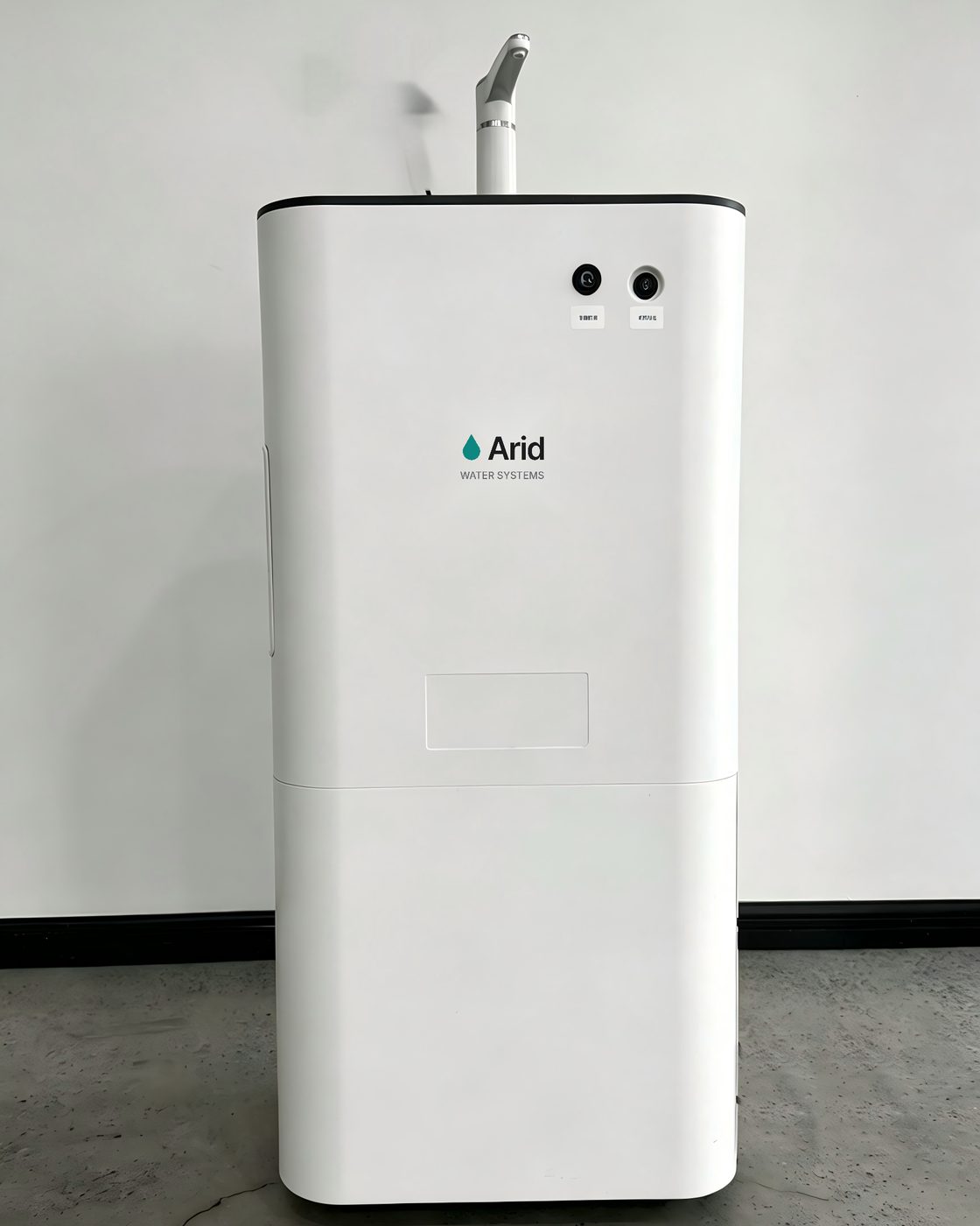 Arid Home atmospheric water harvester demonstration unit, a slim white tower with a dispensing tap on top and the Arid mark on the front